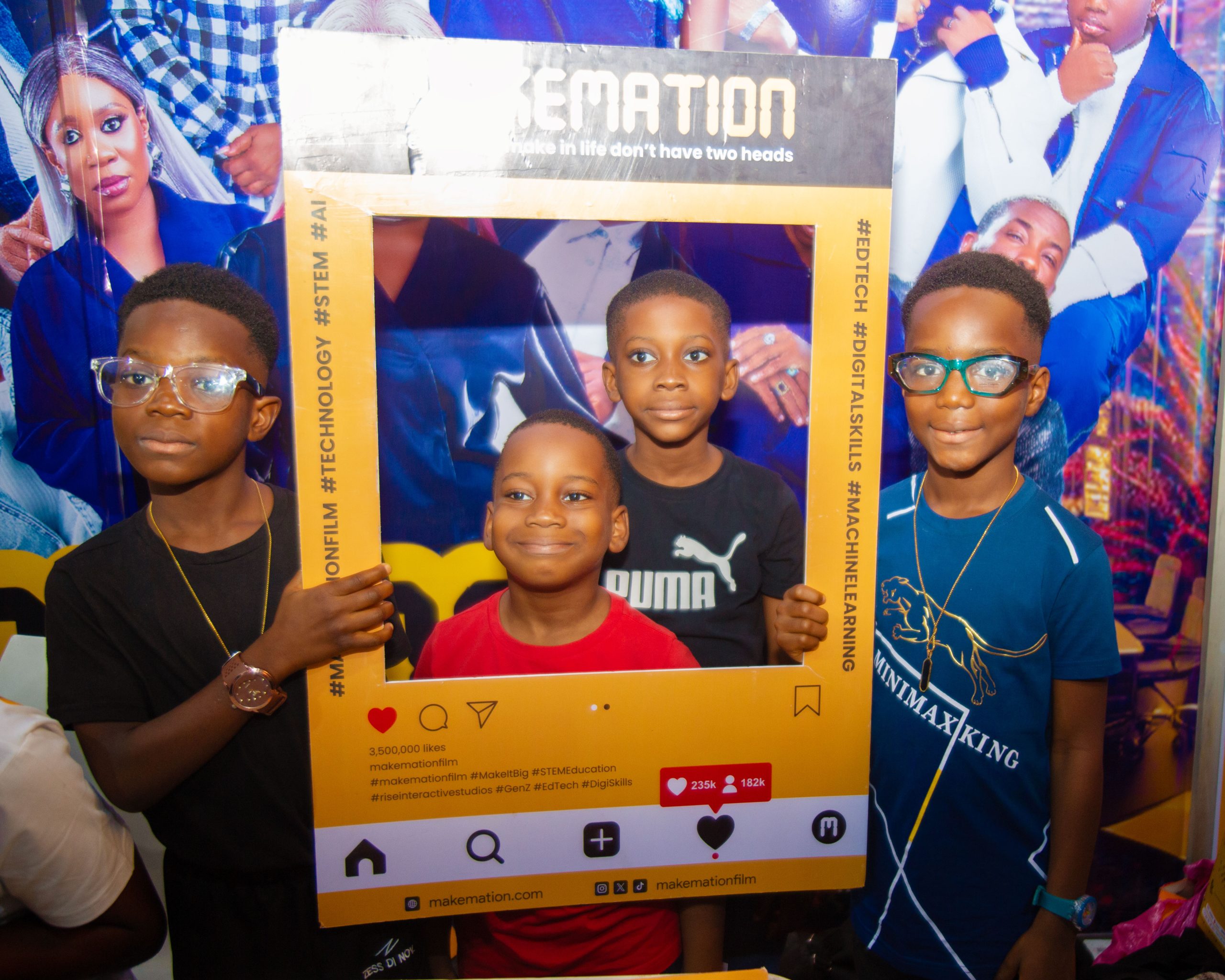 Children posing with MAKEMATION Photo Booth cutouts